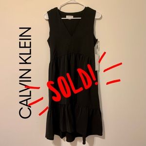 This is a black, Calvin Klein tie-back dress.